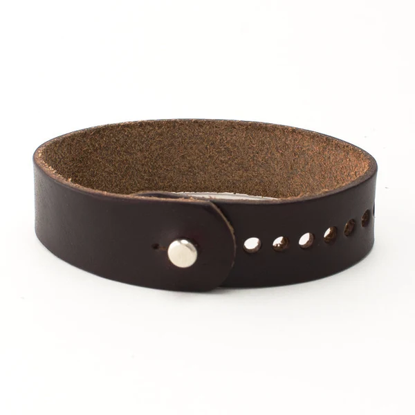 Dark brown leather cuff bracelet with a metal snap and punched holes, shown on a white background.